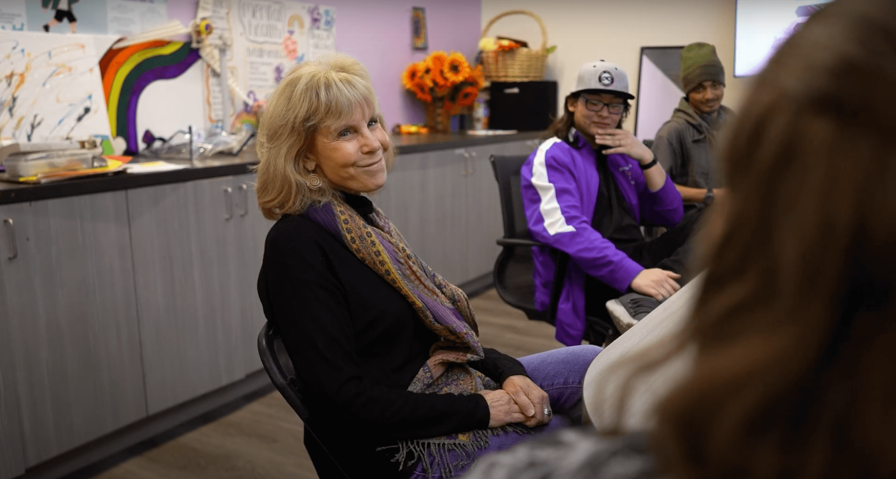 Lynette sitting with clients.