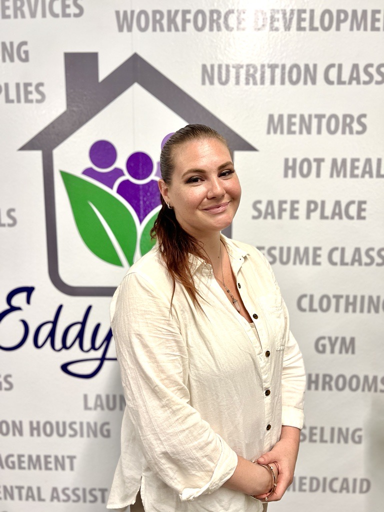 Kelly smiling in front of Eddy House backdrop.