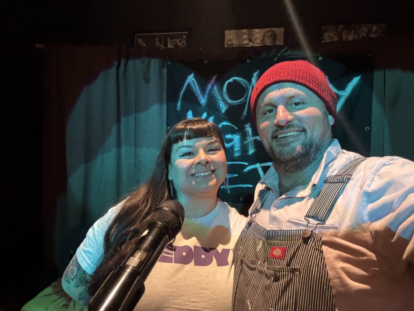 Elisa Garcia and Jesse James Ziegler smile beside a microphone at the Monday Night Poetry fundraiser benefiting Eddy House in Reno.